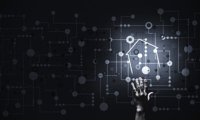 Conceptual image with hand pointing at house or main page icon o