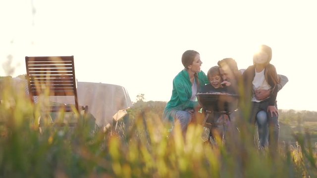 Happy family barbecue in the open air.