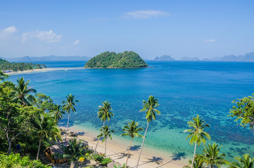 Tropical Beach with Palm trees. Many Islands in ocean in Background, El Nido, Palawan, Philippines