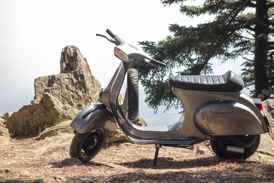 scooter vespa parked in the mountains