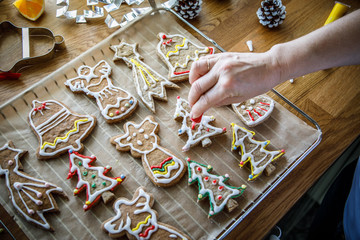 Woman in kitchen making Christmas gingerbread cookies