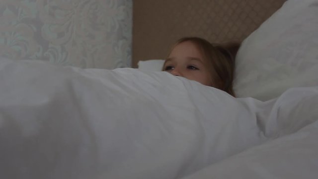 Teenage girl resting, good night sleep concept. Lady enjoys fresh soft bedding linen and mattress in bedroom