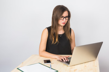 business concept - businesswoman working on laptop in the office