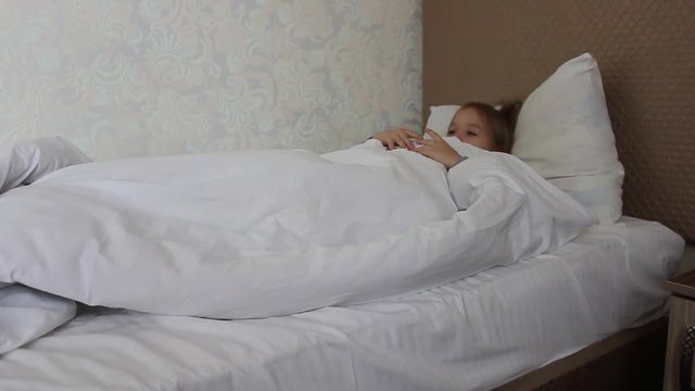 Teenage girl resting, good night sleep concept. Lady enjoys fresh soft bedding linen and mattress in bedroom