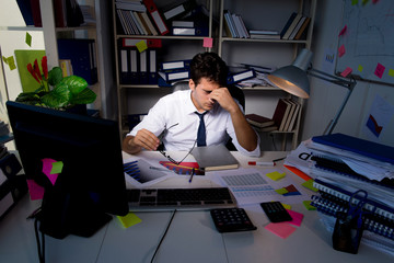 Man businessman working late hours in the office