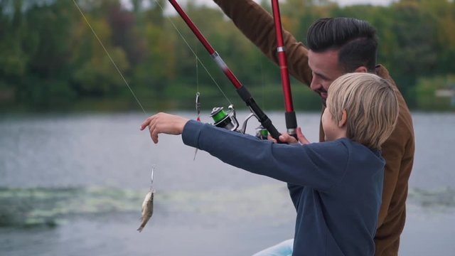 Father with son are fishing.