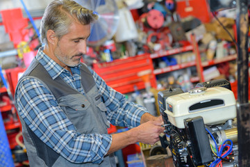 Obraz na płótnie Canvas Mechanic working on generator engine