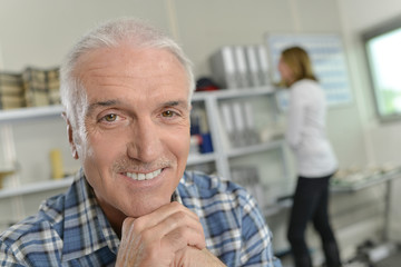 Senior office worker smiling