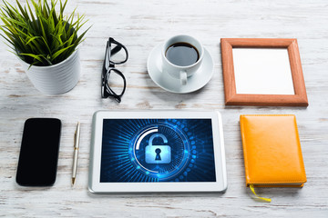 Naklejka premium Web security and technology concept with tablet pc on wooden table