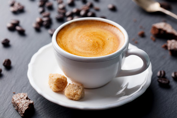 Coffee espresso in white cup on black slate background