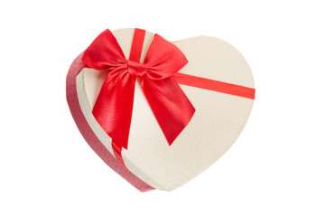 Heart shape gift box with red ribbon for Valentines day or Christmas, new year. Isolated on white
