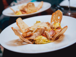 Plate with chicken salad on table