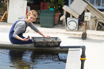 oyster farmer cleans her produce