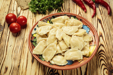 Vareniki (dumplings), pierogi - traditional Ukrainian food,Cooked and served vareniki,pyrohy or dumplings, filled with potato and served with salty caramelized onion,homemade