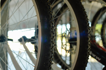 Close up on modern bikes detail over show room abstract shelf background, mobility cycle range