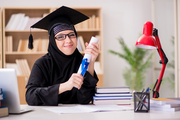 Muslim girl in hijab studying preparing for exams