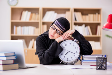 Muslim girl in hijab studying preparing for exams