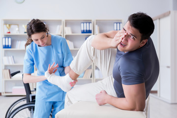 Fototapeta premium Doctor and patient during check-up for injury in hospital