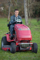 Fototapeta premium Portrait of man driving mower