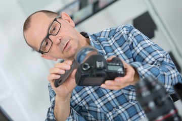 technician examining and repairing dslr camera