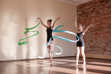 Young ballerinas in motion. Rhythmic gymnastics. Teenage sport, healthy teen lifestyle. Pretty...