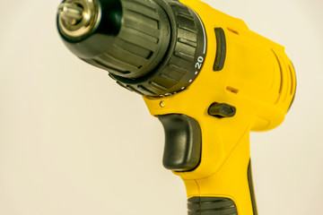 Yellow hand-held cordless screwdriver for professional work.