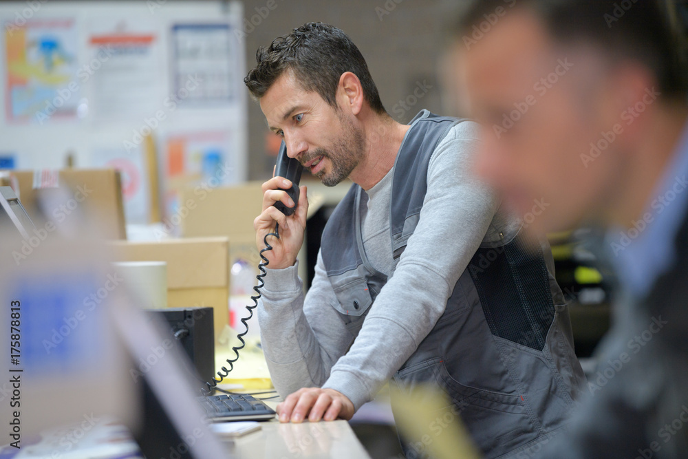 Wall mural businessman on phone at warehouse