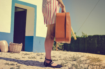 Back view of one lonely woman with suitcase walking on country outdoors road background. Free...