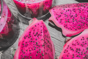 Red Dragon Fruit Juice and Slices with Bokeh or Blur Effect Background 