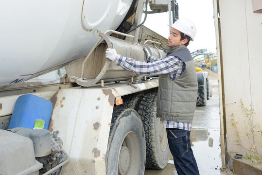 Man adjusting cement lorry