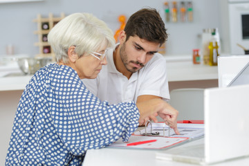 son helping his mother with some document