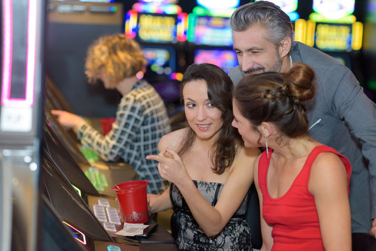 beautiful young people near slot machine in a casino