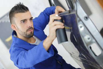 coach builder painting a car