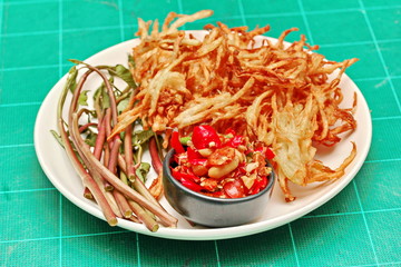 Thai popular recipe, Spicy and sour mixed vegetable salad with fried crispy papaya roll .