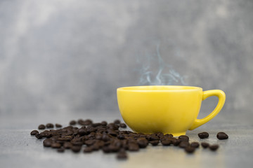 coffee cup and coffee bean with concrete background