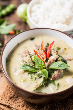 Thai food (Kaeng Khiao Wan),Green curry with pork and cooked rice on wooden background