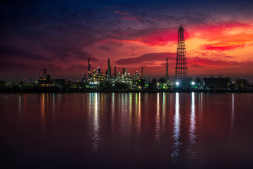 Fototapeta premium Oil and gas industry - refinery at Sunrise - factory - petrochemical plant with reflection over the river