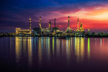 Oil and gas industry - refinery at Sunrise - factory - petrochemical plant with reflection over the...