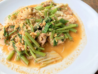 Suki without broths, stir fried mixed vegetable and meat in sukiyaki sauce on white plate on wooden table. Vegetarian Food, healthy food