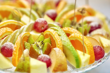 Plate with lots of healthy fruits with sugar powder