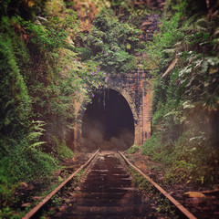 Spooky misty entrance to an abandoned historic railway tunnel in Helensburgh, New South Wales,...