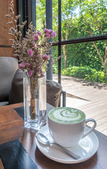 Hot milk green tea with purple flowers