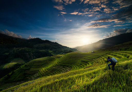 Undefined Photographer taking photo over the Rice fields on terraced of Mu Cang Chai District, YenBai province, Northwest Vietnam