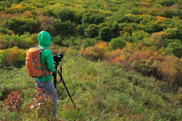 Fototapeta premium Photographer taking photo in beautiful nature
