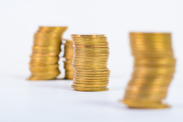 Columns of gold coins, piles of coins on white background