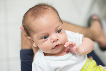 Father holding blue-eyed baby