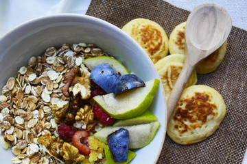 porridge with fruit , berries and pancakes for Breakfast, healthy eating