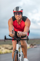 Fototapeta premium Professional cyclist biking on road bike training for triathlon competition on road bicycle in Hawaii. Triathlete working out outdoors. Man sport athlete.