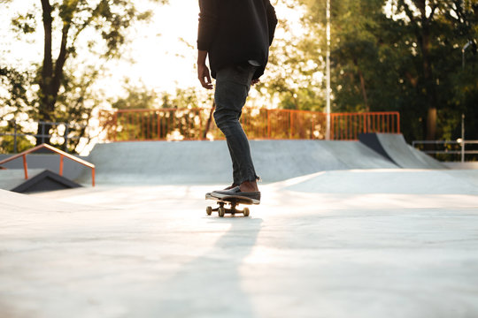 Young man skateboarder on skateboard at city park
