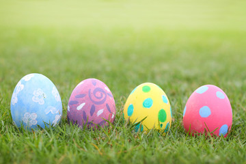 Eggs pastel lined on grass background in ester day